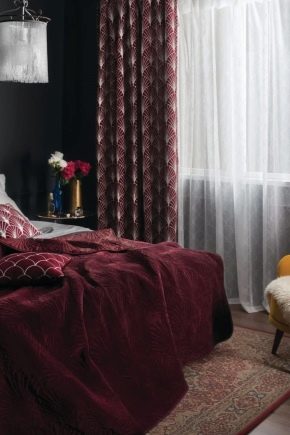 Burgundy curtains in the bedroom interior